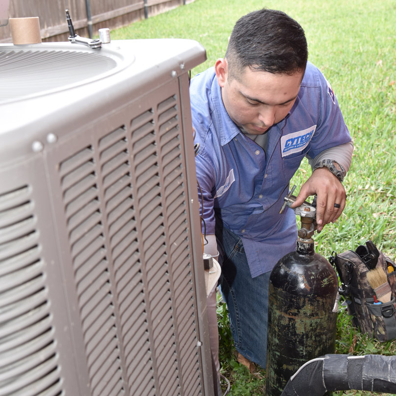 Cytech tech repairing an AC unit